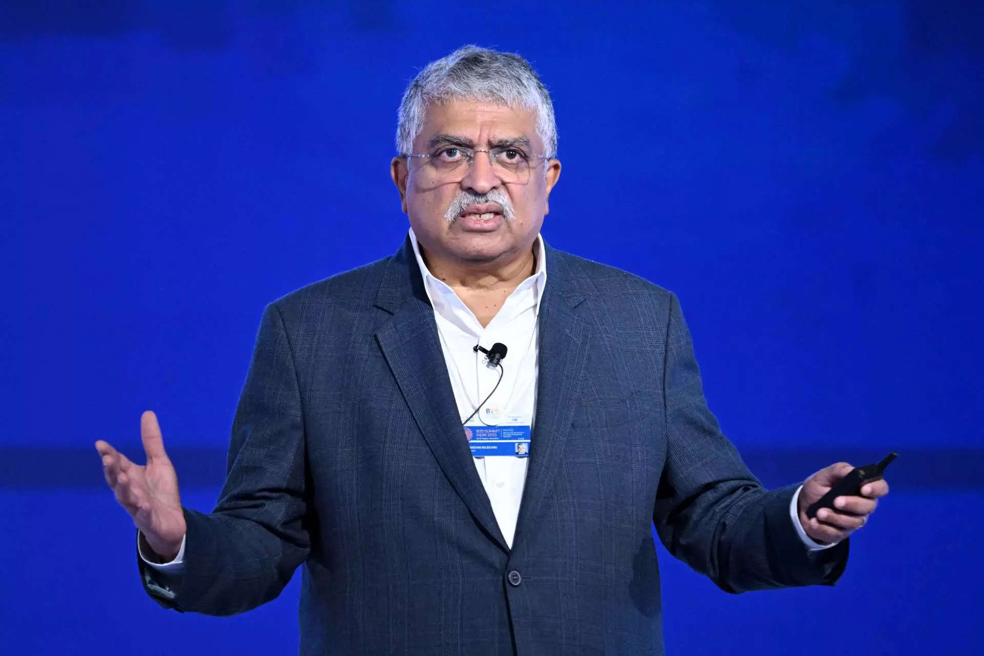 Nandan Nilekani, Chairman and Co-Founder of Infosys and Founding Chairman of UIDAI (Aadhaar), addresses the gathering on the third day of the three-day B20 Summit in New Delhi on August 27, 2023. (Photo by Sajjad HUSSAIN / AFP)